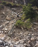 crw_3639 The Paine Circuit was officially closed when we were there because of landslides and rockfall in two sections of the trail from Campamento Paso and Campamento los Guardas. By the time we got there, the rangers had signed and fixed lines on the landslide areas so it was quite easy to get around them. Here, Ray is climbing up a temporary detour at the second (and larger) landslide area.