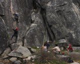 crw_5670 Paul belayed by Danielle on the 5.10c variation of the slab climb with spectators in the background.